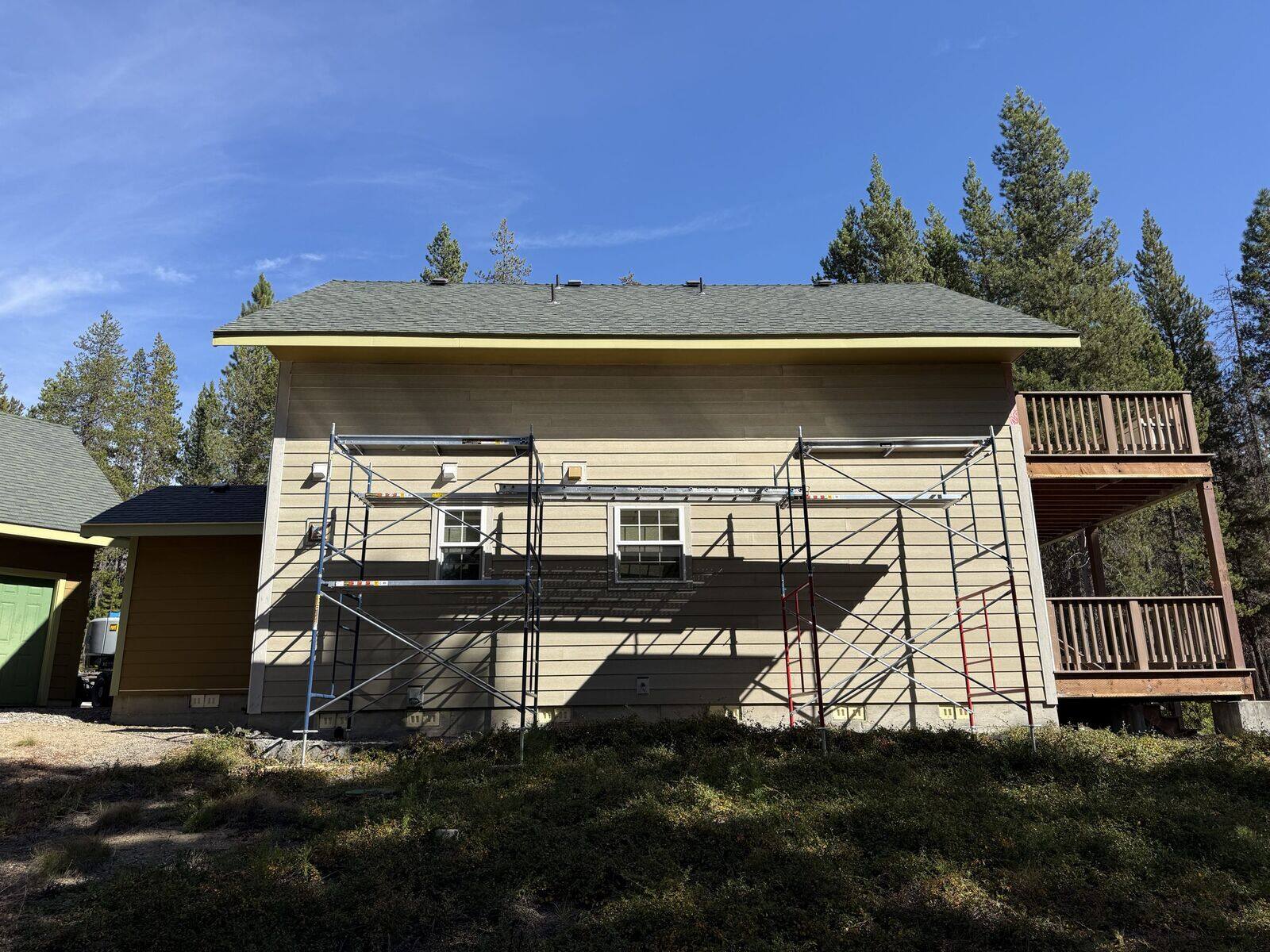Before: Crescent Lake home with old siding and scaffolding