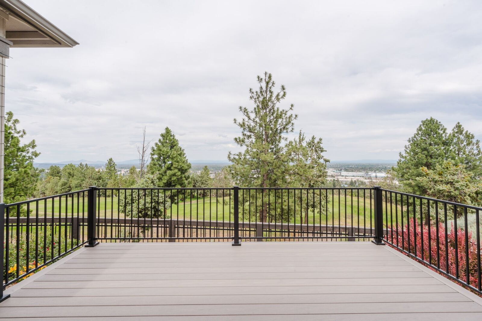 Composite deck with picture-frame border and black steel rail, NW Bend