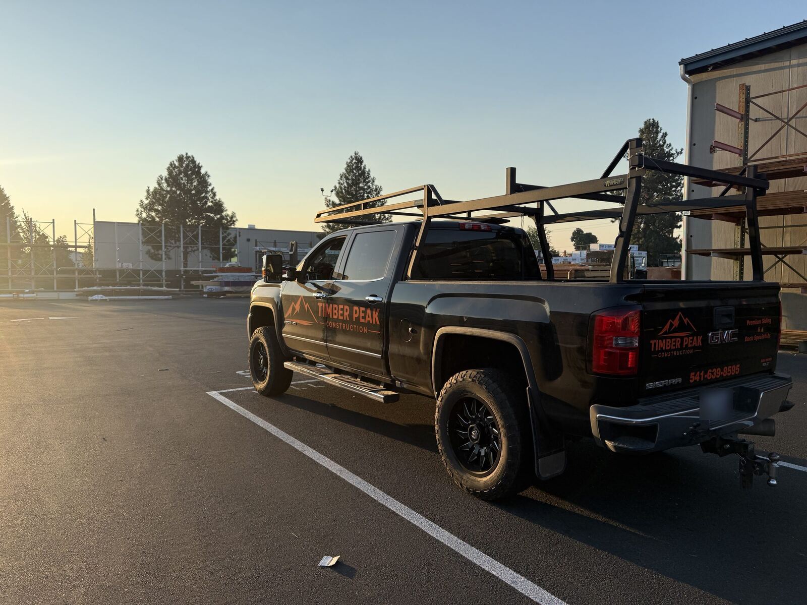 Timber Peak Construction truck with ladder rack at sunrise